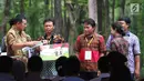 Menteri BUMN Rini Soemarno menyalurkan KUR kepada petani penggarap lahan hutan melalui Program Perhutanan Sosial di Tuban, Jawa Timur, Jumat (9/3). Peyaluran ini merupakan tahap kedua pada tahun 2018. (Liputan6.com/Angga Yuniar)