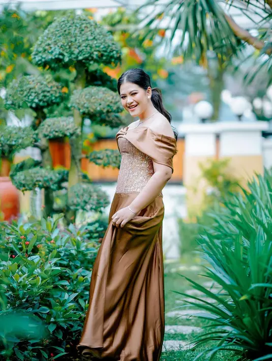 Ibu dua anak ini juga terlihat elegan dengan off shoulder dress satin berwarna bronze dari desainer Hendy Huang.[@ayanggkahiyang]