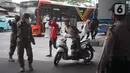 Petugas memberhentikan warga pelanggar Operasi Yustisi Pencegahan Covid-19 di kawasan Kampung Melayu, Jakarta Timur, Senin (16/11/2020). Operasi tersebut digelar guna menyadarkan masyarakat akan pentingnya penggunaan masker di tengah pandemi Covid-19. (Liputan6.com/Immanuel Antonius)