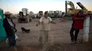 Sejumlah petugas berjaga di dekat alat berat yang tersisa di lokasi pembangunan pabrik Ford di di Villa de Reyes, San Luis Potosi, Meksiko, (4/1). (AP Photo/Rebecca Blackwell)