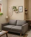 Rumah kecil dengan ruang tamu dan ruang makan menyatu sehingga terlihat elegan untuk hunian KPR dan subsidi model sofa menghadap dinding dan meja makan di belakangnya (AI generated)