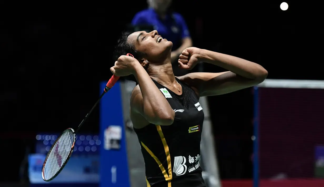 Pebulu tangkis Putri India, Pusarla Venkata Sindhu merayakan kemenangan atas Nozomi Okuhara dari Jepang pada babak final Kejuaraan Dunia Bulu Tangkis 2019 di Swiss, Minggu (25/8/2019). Pursala menjadi pebulu tangkis India pertama yang berhasil meraih gelar juara dunia. (FABRICE COFFRINI/AFP)