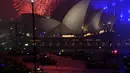 Kembang api menghiasi langit di atas Gedung Opera dan Jembatan Harbour sekitar 3 jam saat pergantian tahun di Sydney (01/1/2018). Langit di Sydney dihujani 13 ribu kembang api jenis shell dan 30 ribu kembang api jenis komet. (AFP Photo / Saeed Khan)