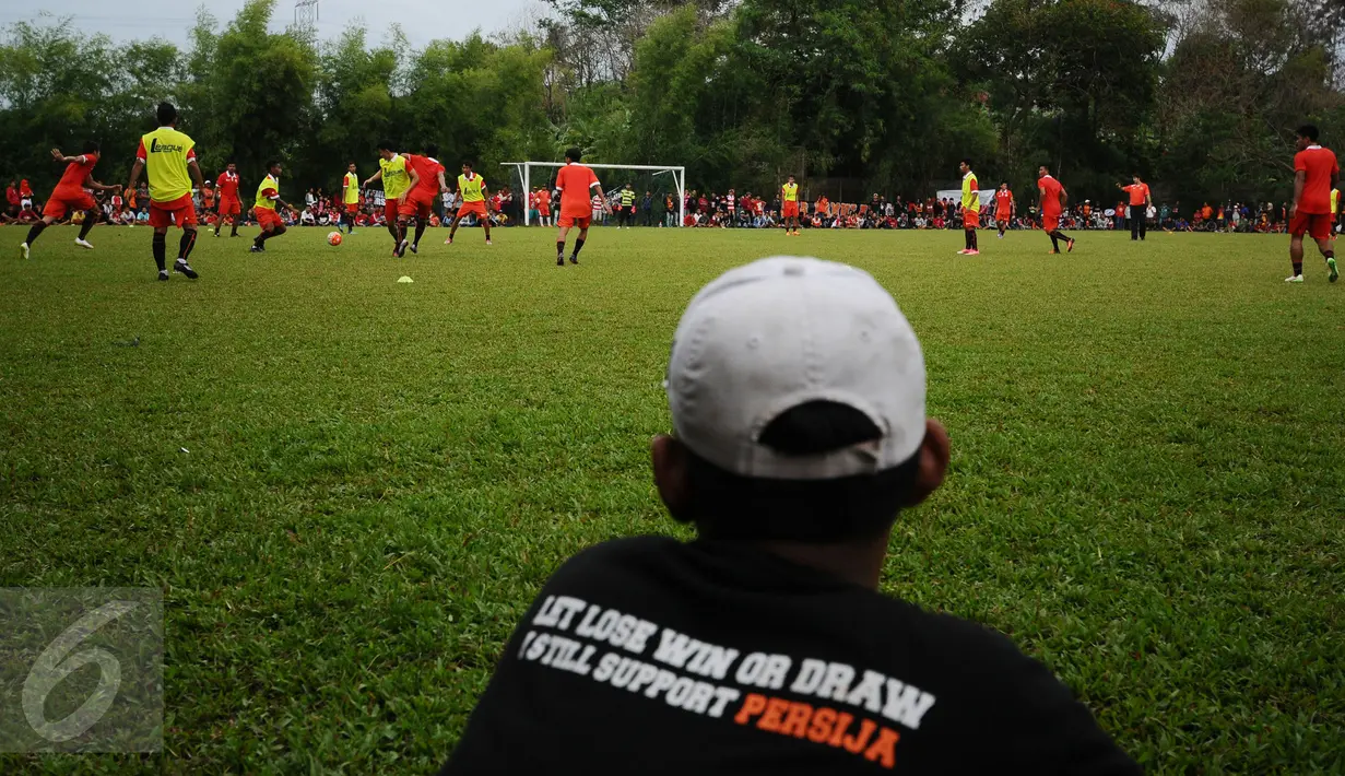 Salah satu suporter menggunakan kaos dukungan saat menyaksikan sesi latihan Persija di NYTC, Sawangan, Depok, Selasa (24/1). Jelang kompetisi musim 2017, Persija melakukan latihan rutin di National Youth Training Centre. (Liputan6.com/Helmi Fithriansyah)