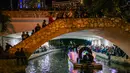 Warga melihat kendaraan hias melintas selama parade Hari Sungai Mati di San Antonio, Texas, Amerika Serikat, 29 Oktober 2021. Warga berkumpul untuk merayakan, memperingati, dan mengenang orang-orang terkasih yang telah meninggal untuk Día de los Muertos tahun ini. (Brandon Bell/Getty Images/AFP)