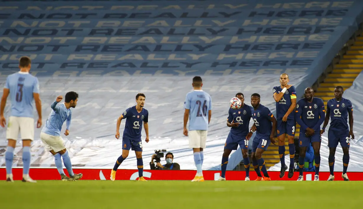 Gelandang Manchester City, Ilkay Gundogan, mencetak gol melalui tendangan bebas ke gawang FC Porto pada laga Liga Champions di Stadion  Etihad, Kamis (22/10/2020). City menang dengan skor 3-1. (Phil Noble/Pool via AP)