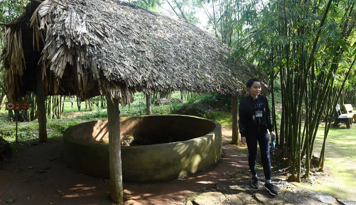 Seorang pemandu wisata berdiri di samping sebuah sumur udara yang digunakan untuk ventilasi Terowongan Vinh Moc di Distrik Vinh Moc, Provinsi Quang Tri, Vietnam, Kamis (18/1). (AFP PHOTO/HOANG DINH NAM)