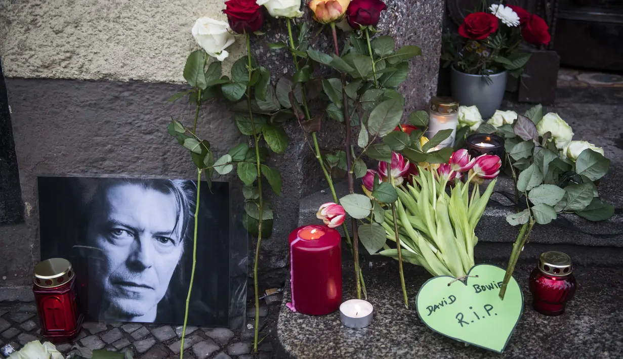 Upeti legenda rock asal Inggris, David Bowie terlihat di luar bekas rumahnya di Berlin Hauptstrasse 155 pada 11 Januari 2016. Kabar meninggalnya musisi legendaris ini dikabarkan melalui akun resmi Twitter dan Facebook-nya. (AFP/Bintang.com)