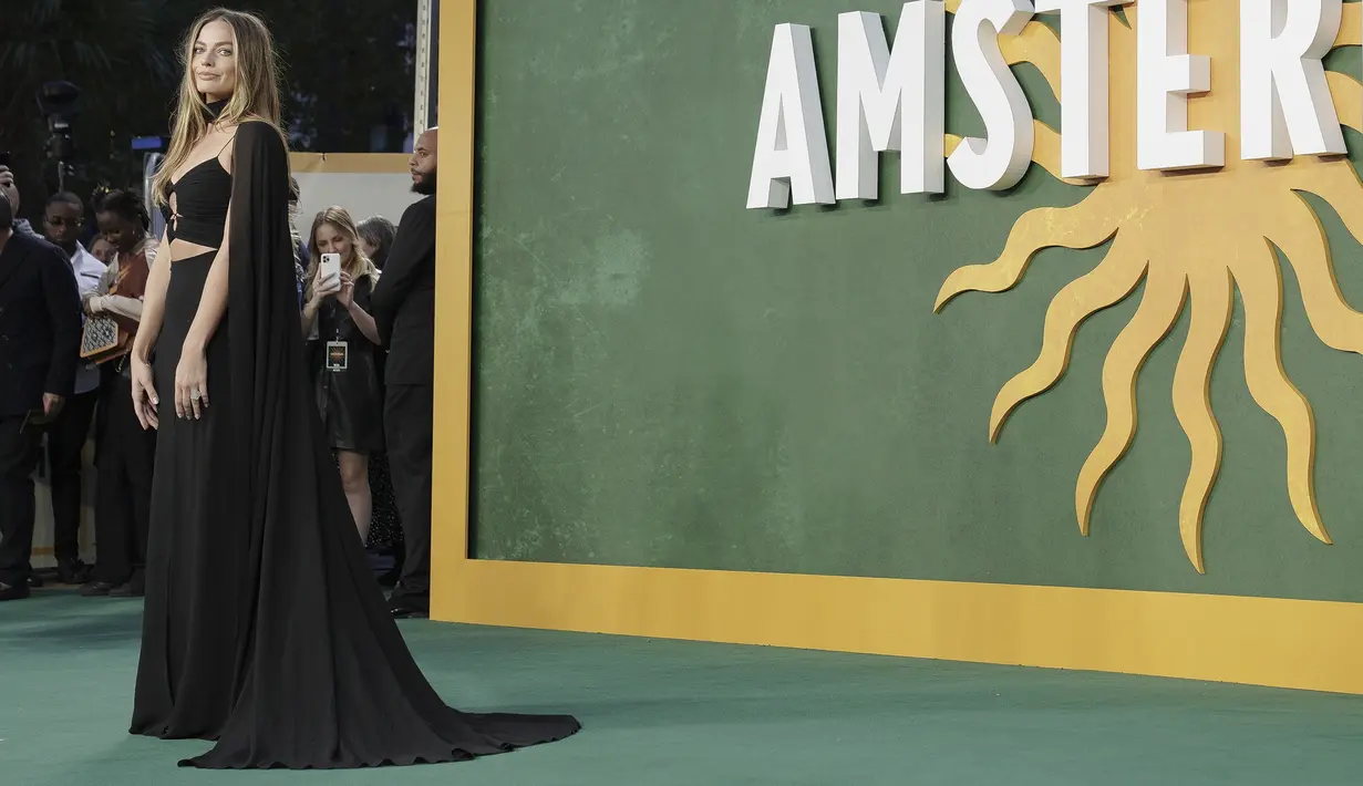 Margot Robbie berpose untuk fotografer setibanya di pemutaran perdana film 'Amsterdam' di London, Rabu, 21 September 2022. Adapun glamnya, Margot memiliki rambut pirang yang disorot ke bawah dan berpisah di tengah sementara lurus alami sementara mata smokey gerah dan bibir telanjang mengkilap melengkapi penampilannya. (Photo by Vianney Le Caer/Invision/AP)