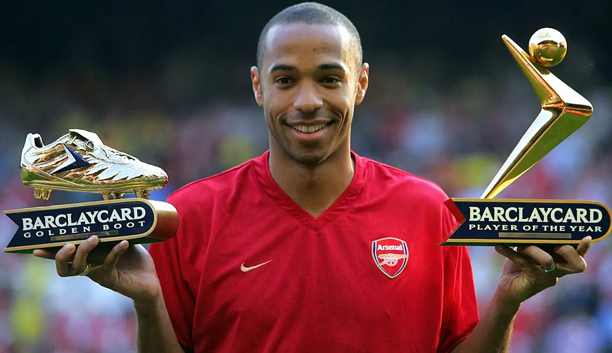 Striker Arsenal, Thierry Henry berpose dengan trofi Golden Boot dan Player of The Year Liga Inggris musim 2003/2004 jelang laga testimoni Martin Keown di Highbury, London (17/5/2004). Thierry henry merebut trofi Sepatu Emas Eropa edisi 2004 setelah mencetak total 30 gol bagi Arsenal di Liga Inggris musim 2003/2004, sekaligus mempersembahkan trofi juara Liga Inggris. Setelah hijrah ke Barcelona pada 2004/2005 ia kembali meraih Sepatu Emas bersanding dengan Diego Forlan (Villarreal) yang sama-sama mencetak 25 gol. (AFP/Odd Andersen)