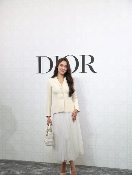 Ia padukan blazer broken white dengan rok tutu putih dan J'Adior Sling Back Pump