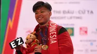Medali emas Rahmat Erwin Abdullah di SEA Games 2021 ini sekaligus mempertahankan medali emas yang diraihnya pada SEA Games 2019 Filipina. Dengan angkatan total 345 kg, ia berhasil memecahkan rekornya sendiri yang dibuat di SEA Games 2019 Filipina dengan total angkatan 322 kg. (Bola.com/Ikhwan Yanuar)