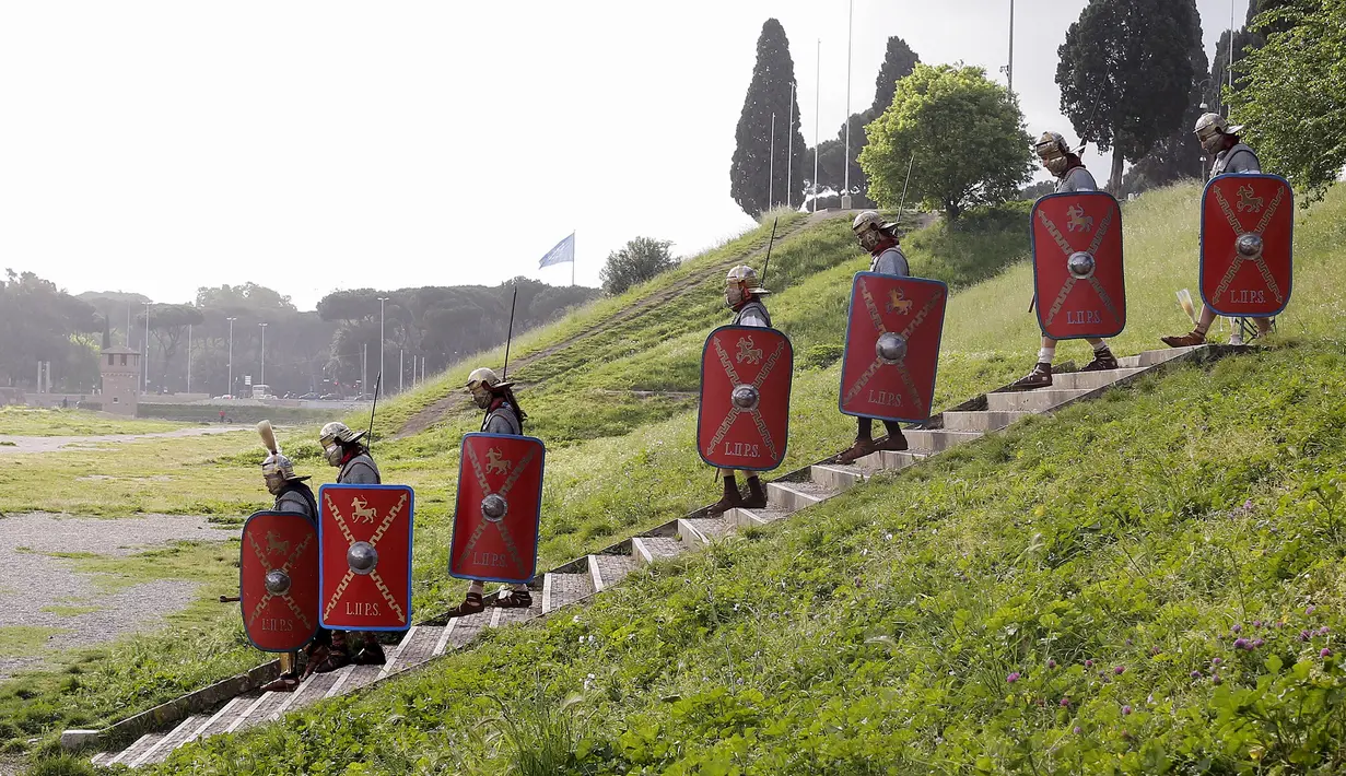 Sejumlah anggota Gruppo Storico Romano (Grup Sejarah Roma) berpakaian perang lengkap dengan tameng dan senjata di Circus Maximus, Roma, Italia , (24/4). Kegiatan ini untuk merayakan ulang tahun berdirinya Roma yang ke-2769. (REUTERS / Alessandro Bianchi)