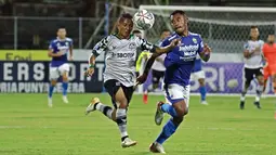 Pemain Persikabo 1973, Hendra Adi Bayauw (kiri) berebut bola dengan pemain Persib Bandung, Ardi Idrus saat laga pekan ke-21 BRI Liga 1 2021/2022 di Stadion I Gusti Ngurah Rai, Denpasar, Sabtu (29/1/2022). Laga berakhir dengan skor 1-0 untuk kemenangan Maung Bandung. (Bola.com/Nandang Permana)