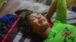 Ekspresi Hasina Aktar saat melahirkan di sebuah pusat medis di kamp pengungsian Kutupalong (11/10). Hasina Aktar berhasil melahirkan seorang bayi laki-laki yang diberi nama Mohammed Jubayed. (AFP Photo/Munir Uz Zaman)