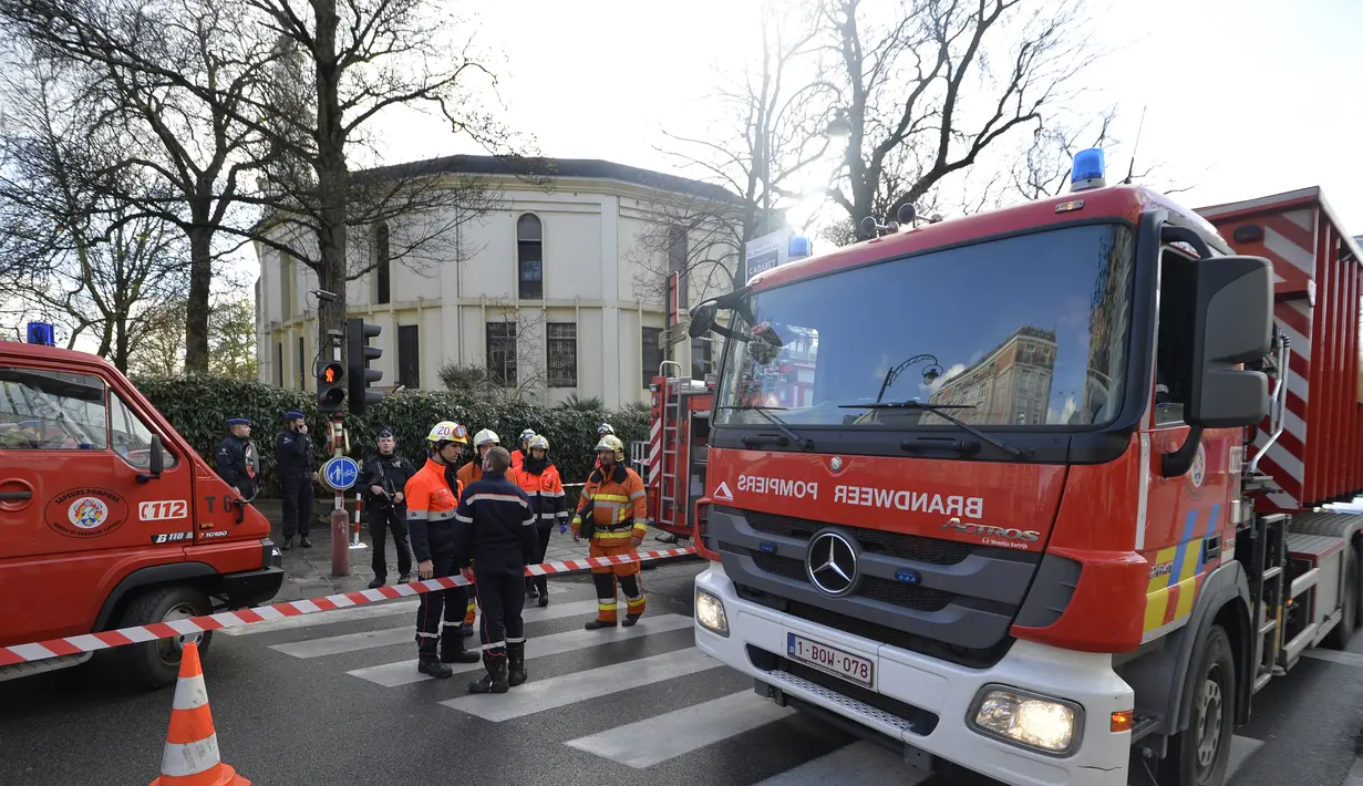 Sejumlah petugas pemadam kebakaran berdiri di luar Masjid Agung Brussels, Belgia, setelah ditemukan paket berisikan serbuk putih yang dikhawatirkan Anthrax, Kamis (26/11). Petugas juga mengevakuasi 11 orang didekontaminasi. (AFP PHOTO/BELGA/ERIC LALMAND)