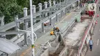 Sejumlah pekerja menyelesaikan pembangunan selter di kawasan Stasiun Palmerah, Jakarta, Selasa (2/2/2021). Penataan kawasan Stasiun Palmerah mencakup pembangunan selter untuk bus, angkot, dan ojek online. (Liputan6.com/Faizal Fanani)