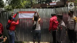 Penyidik Bareskrim Polri menyegel rumah yang diduga milik Indra Kesuma atau Indra Kenz di Cluster Narada Sutera Alam Sutera, Serpong Utara, Tangerang Selatan, Jumat (18/3/2022). Pengejaran aliran dana Indra Kenz termasuk ke orang-orang dan aset-aset yang dimilikinya. (Liputan6.com/JohanTallo)