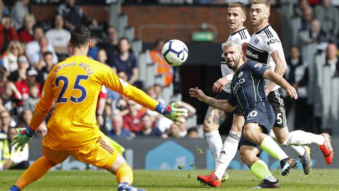 Striker Manchester City Sergio Aguero (biru gelap) mencetak gol ke gawang Fulham pada lanjutan Liga Inggris di Craven Cottage, Sabtu (30/3/2019). (AFP/Adrian Dennis)