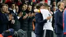 Penyerang Jerman, Lukas Podolski memeluk pelatihnya Joachim Loew saat pertandingan persahabatan melawan Inggris di Dortmund, (23/3). Podolski melakukan 130 penampilan bersama Die Mannschaft. (AP Photo/Frank Augstein)