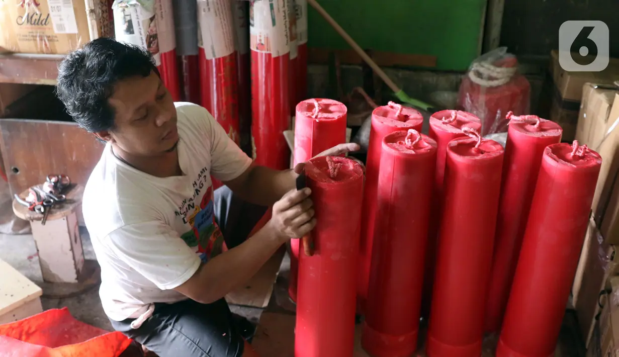 Pekerja merapikan lilin untuk perayaan Tahun Baru Imlek di Tangerang, Banten, Kamis (4/2/2021). Tahun Baru Imlek pada 12 Februari 2021 mendatang kemungkinan digelar tanpa perayaan besar karena pandemi COVID-19. (Liputan6.com/Angga Yuniar)