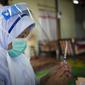 Petugas medis menyiapkan vaksin COVID-19 Pfizer untuk seorang wanita lansia di pedesaan Sabab Bernam, Selangor, Malaysia, Selasa (13/7/2021). Tim medis pergi dari rumah ke rumah di desa terpencil untuk menjangkau warga lansia dalam upaya meningkatkan program vaksinasi. (AP Photo/Vincent Thian)