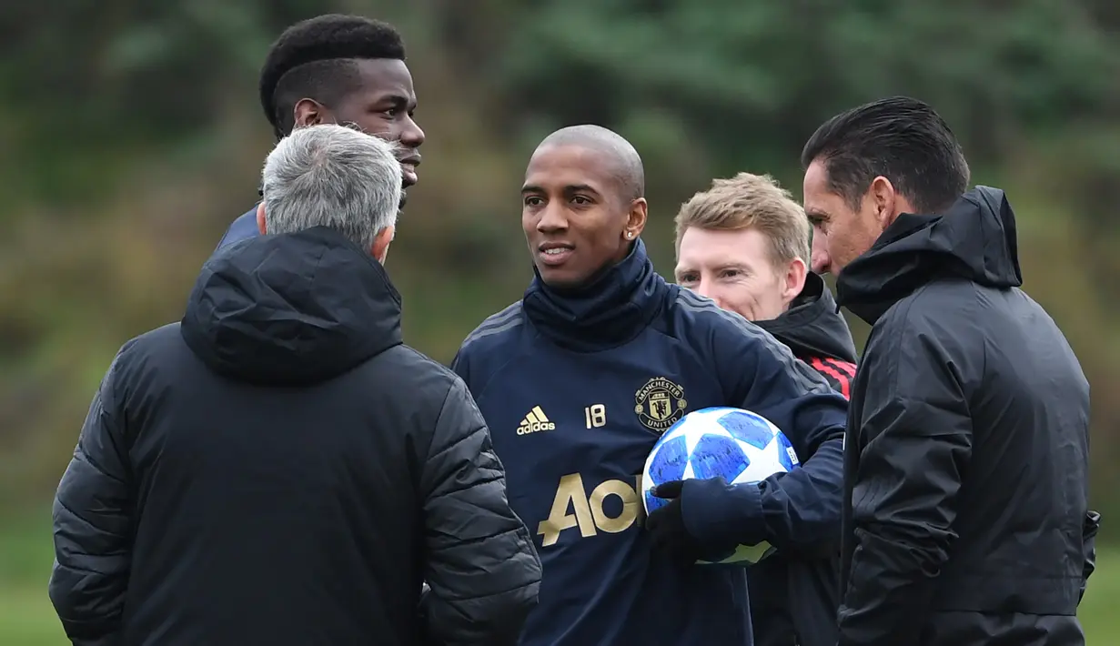 Gelandang Manchester United, Ashley Young berbincang dengan pelatih Jose Mourinho saat sesi latihan tim di Carrington di Manchester, Inggris (6/11). MU akan bertanding melawan wakil Italia, Juventus pada grup H Liga Champions. (AFP Photo/Paul Ellis)
