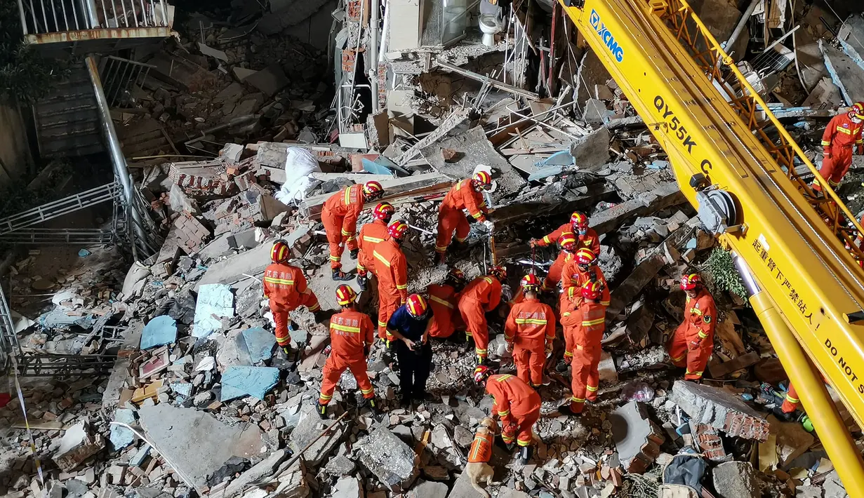 Petugas penyelamat sedang menggali sisa-sisa hotel yang runtuh untuk mencari korban selamat  di Suzhou di Provinsi Jiangsu, China timur (12/7/2021). Insiden itu menyebabkan setidaknya satu orang tewas dan 10 lainnya hilang, lapor kantor berita negara CCTV. (AFP/CNS)