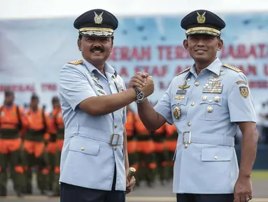 Panglima TNI Marsekal Hadi Tjahjanto (kiri), KSAU Marsekal TNI Yuyu Sutisna bersalam komando usai mengikuti upacara serah terima jabatan KSAU di Lapangan Udara Halim Perdanakusuma, Jakarta, Jumat (19/1). (Liputan6.com/Faizal Fanani)