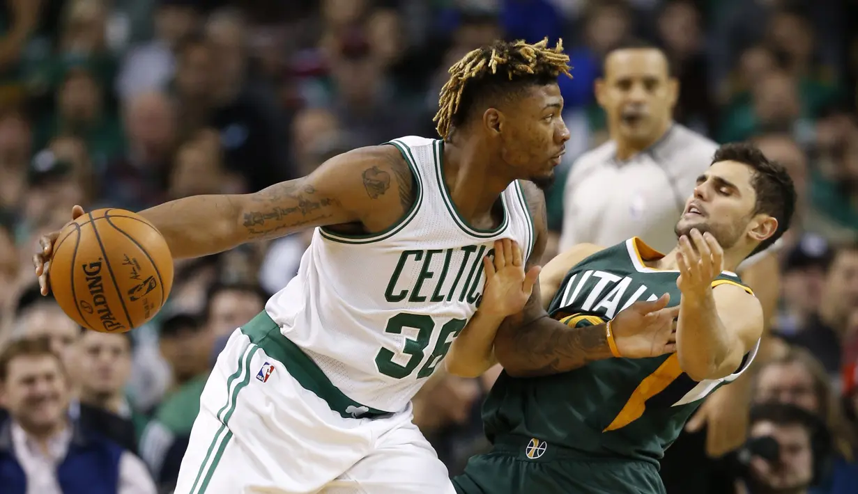 Pemain Boston Celtics, Marcus Smart (36) mencoba melewati hadangan pemain Utah Jazz, Raul Neto (25) pada lanjutan NBA di TD Garden. Boston Celtics menang 115-104.  (Reuters/Greg M. Cooper-USA TODAY Sports)