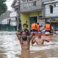 Warga melintasi banjir di perumahan Ciledug Indah, Tangerang, Rabu (1/1/2020). Banjir setinggi dada orang dewasa terjadi akibat meluapnya kali angke. (Liputan6.com/Angga Yuniar)