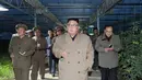 Pemimpin Korea Utara Kim Jong-un ditemani ajudannya saat mengunjungi Jungphyong Vegetable Greenhouse Farm and Tree Nursery yang sedang dibangun di Kyongsong, Korea Utara, Jumat (18/10/2019). Kunjungan tersebut untuk memastikan pasokan makanan stabil. (KCNA VIA KNS/AFP)