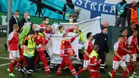 Christian Eriksen mendapat perawatan setelah kolaps dalam pertandingan Denmark kontra Finlandia di Parken Stadium, Sabtu (13/6/2021). (AFP/Wolfgang Rattay)