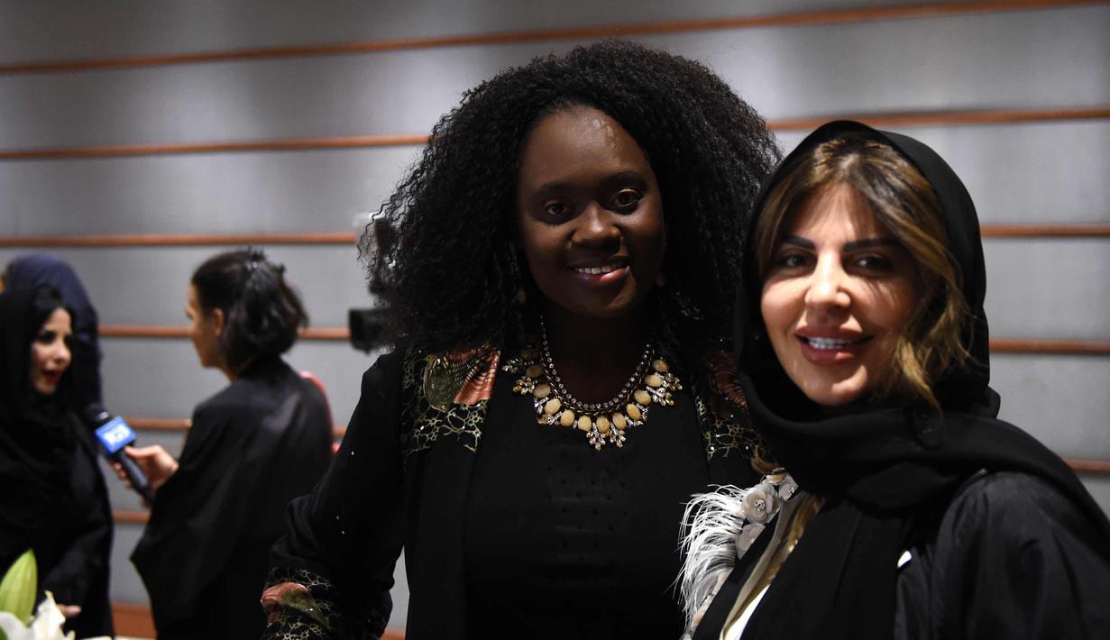 Dua wanita tersenyum saat menghadiri upacara pembukaan Arab Fashion Week di hotel Ritz Carlton di Riyadh (10/4). Arab Fashion Week akan berlangsung hingga 14 April 2018. (AFP Photo/Fayez Nureldine)