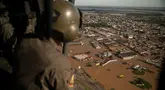 Seorang anggota militer mengamati dari helikopter jalanan yang terendam banjir di kota El Dorado do Sul, negara bagian Rio Grande do Sul, Brasil, pada tanggal 8 Mei 2024. (Carlos FABAL/AFP)