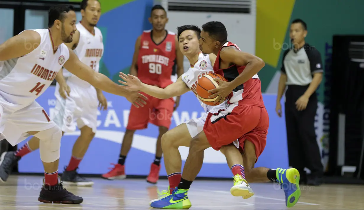 Pemain Timnas Basket Indonesia, Prastawa (tengah) gagal membendung laju pemain Timor Leste pada laga perdana test event Basketball Asian Games 2018 di Hall A Senayan, Jakarta, Rabu (7/2/2018).  Indonesia menang 135-30. (Bola.com/Nicklas Hanoatubun)