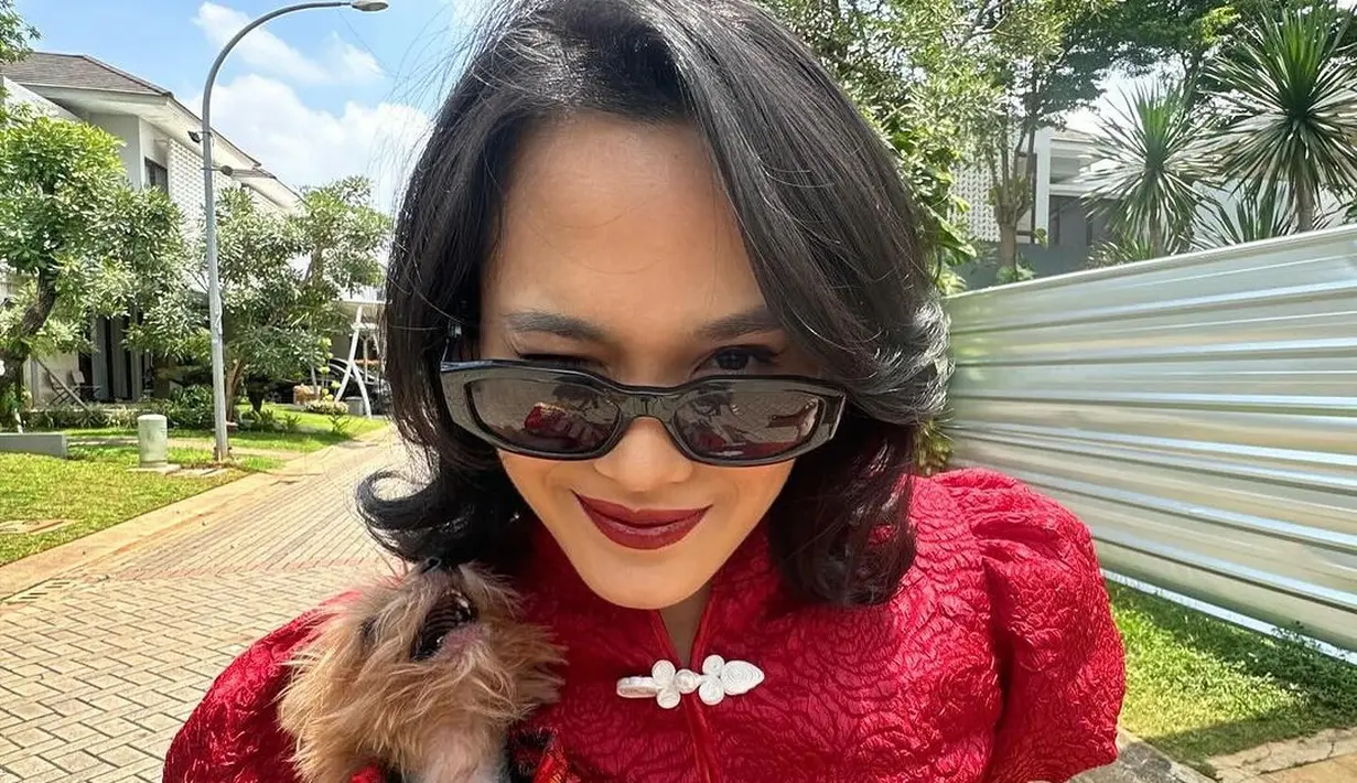 Sheryl Sheinafia kenakan cheongsam dengan gaya yang lebih edgy. Ia kenakan cropped top dengan desain cheongsam dan balloon sleeve yang terlihat manis. Dipadukan dengan celana abu-abu dan kacamata hitam [@sherylsheinafia]