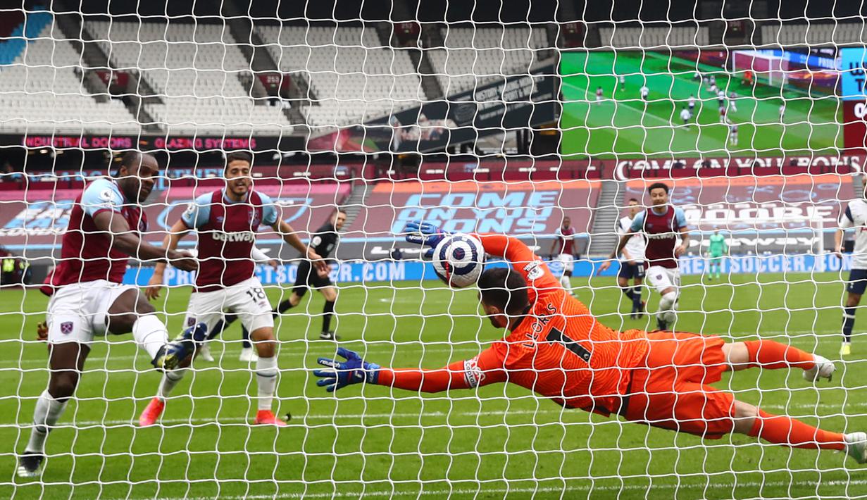 Gelandang West Ham United, Michail Antonio (kiri) melepaskan tendangan yang berbuah gol pertama timnya ke gawang Tottenham Hotspur dalam laga lanjutan Liga Inggris 2020/21 pekan ke-25 di The London Stadium, Minggu (21/2/2021). West Ham menang 2-1 atas Tottenham. (AFP/Clive Rose/Pool)