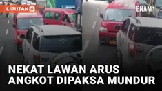 Aksi tidak mematuhi peraturan lalu lintas dilakukan oleh pengemudi angkot yang melawan arus jalan mengundang perhatian