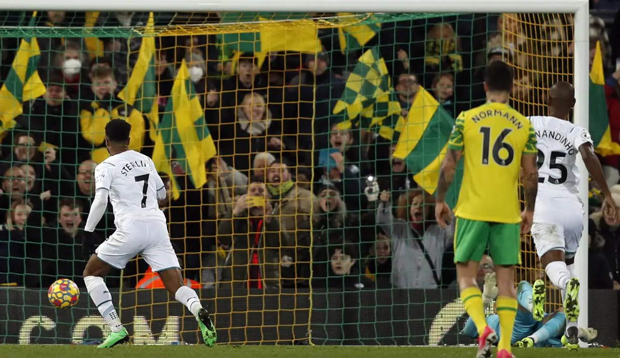 Pemain Manchester City Raheem Sterling mencetak gol setelah tendangan penaltinya pada awalnya diselamatkan oleh kiper Norwich City Angus Gunn pada pertandingan sepak bola Liga Inggris di Stadion Carrow Road, Norwich, Inggris, 12 Februari 2022. Manchester City menang 4-0. (Adrian DENNIS/AFP)