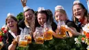 Para wanita memegang gelas berisi bir saat festival bir 'Oktoberfest' ke-188 di Munich, Jerman, Sabtu (16/9/2023). Aliran bir dan kerumunan orang berdatangan ke Munich untuk menyambut dimulainya Oktoberfest secara resmi. (AP Photo/Matthias Schrader)
