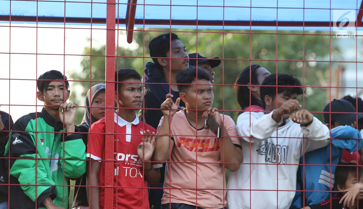 Suporter tim Macan Kemayoran menyaksikan latihan perdana Persija pasca menjuarai Liga 1 musim 2018 di Lapangan Wisma Aldiron, Jakarta, Senin (7/1). 30 pemain ikut dalam latihan perdana yang digelar terbuka. (Liputan6.com/Helmi Fithriansyah)