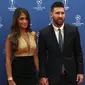 Penyerang Barcelona, Lionel Messi bersama istrinya Antonella Roccuzzo berpose saat tiba menghadiri acara undian penyisihan grup Liga Champions UEFA dan pemain terbaik Eropa di Forum Grimaldi, Monaco (29/8/2019). (AP Photo/Daniel Cole)