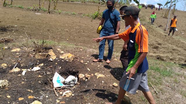 Piyono saat menunjukkan titik semburan kecil yang dulunya muncul api kecil seperti api abadi di Mrapen, Grobogan. Saat ini, sudah padam karena ditutup bebatuan oleh warga (Liputan6.com/Ahmad adirin)