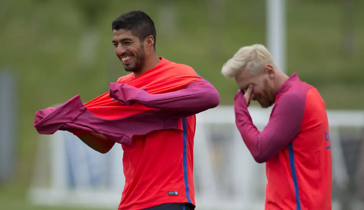 Luis Suarez dan Messi teratawa bersama pada sesi latihan jelang laga melawan Celtic pada ajang International Champions Cup 2016 di St George's Park, Inggris (25/7/2016). (AFP/Oli Scarff)