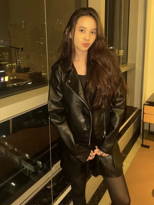 Rambut panjang tampak bervolume, ia pun tampil memesona. Sybil mengenakan gaya serba hitam dengan jaket dan mini skirt leather dipadukan stocking warna senada.  [@kana.sybilla]