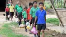 Gambar pada 20 Mei 2019, siswa India mengantre membawa tas plastik berisi sampah plastik di sekolah Forum Akshar di desa Pamohi, Guwahati. Sekolah ini mengambil pendekatan baru untuk mengatasi momok sampah plastik dengan menjadikannya sebagai syarat pengganti biaya sekolah. (Biju BORO/AFP)