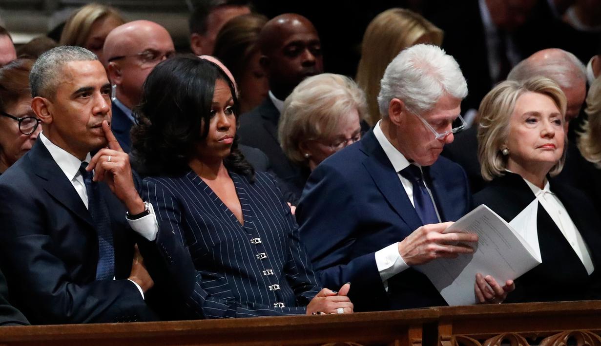 Mantan Presiden AS, Barack Obama dan Michelle Obama duduk bersebelahan dengan mantan presiden Bill Clinton dan Hillary Clinton saat prosesi pemakaman kenegaraan George HW Bush di Katedral Nasional Washington, Rabu (5/12). (Alex Brandon/POOL/AFP)