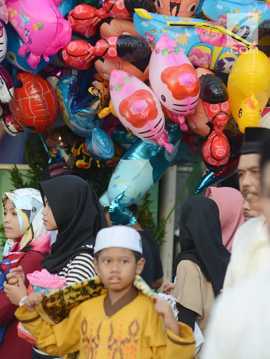Pedagang balon berjualan di dekat lokasi pelaksanaan salat Idul Fitri 1 Syawal 1440 Hijriah di Jatinegara, Jakarta,Rabu (5/6/2019). Pemerintah menetapkan Idul Fitri 1440 Hijriah dirayakan secara nasional pada hari ini. (merdeka.com/Imam Buhori)