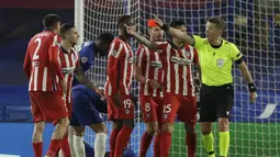 Wasit Daniele Orsato menunjukkan kartu merah ke bek Atletico Madrid Stefan Savic (kedua kanan) setelah melanggar bek Chelsea Antonio Rudiger pada leg kedua 16 besar Liga Champions di Stadion Stamford Bridge, Kamis dinihari WIB (18/3/2021). Chelsea mengalahkan Atletico 2-0. (AP Photo/Matt Dunham)
